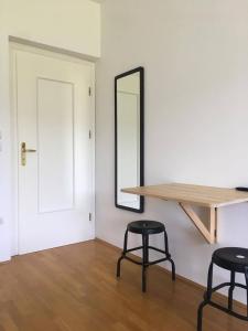 a room with two stools and a mirror and a table at Guest House Vitaja in Bled