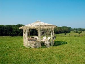 a metal gazebo in a field of grass at Hotel Klaus Störtebeker in Ralswiek