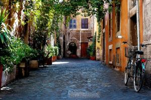 an alley with a bike parked on a cobblestone street at Casa delle Eroidi in Rome
