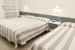Postel nebo postele na pokoji v ubytování Hotel Aurea