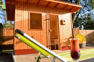 a small wooden house with a drink and a drink at Hotel Lukács Superior in Kazincbarcika