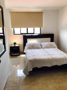 a bedroom with a bed and a window at Hotel Mirador de Santa Bárbara in Socorro