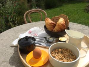 a table with a tray of bread and a bowl of food at Tinsmiths House in Aylsham