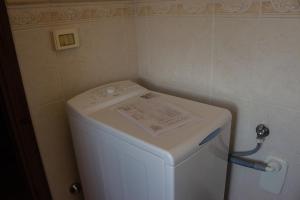 a white refrigerator with a paper on top of it at Country House Carmelita in Limigiano