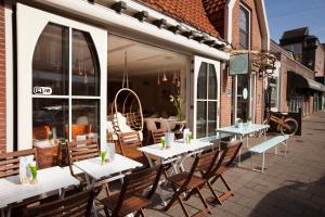 a patio with tables and chairs outside of a restaurant at Koningshof in Alkmaar