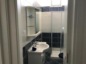 a small bathroom with a sink and a shower at Casa Gada in Torre Lapillo +21 photos