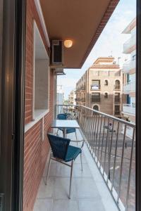 a balcony with two chairs and a table at Prado in Peniscola
