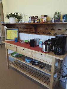 a wooden shelf with pots and pans on it at Retkeilymaja Virkkula in Kuopio
