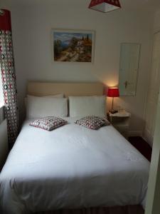 a bedroom with a white bed with two pillows at Lettermore Country Home in Rathdrum