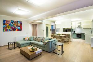 a living room with a couch and a table at Hidden Sanctuary In Saronida in Anavyssos