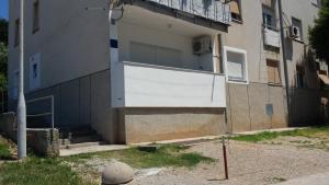 budynek z białymi drzwiami na boku w obiekcie Apartman Zoja w miejscowości Mali Lošinj