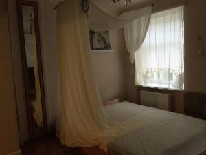 a bedroom with a bed and a window at Heart of Lviv in Lviv