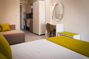 a bedroom with a bed and a desk and a mirror at KalyBay in Kalives Poligirou +43 photos