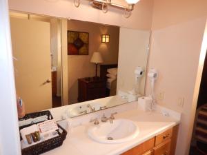 uma casa de banho com um lavatório e um espelho grande em Mount Shasta Resort em Mount Shasta
