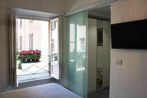 a room with a large window and a television at La Marina di Milano in Milan