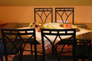 a dining room table with a plate and two chairs at Vadviraghaz in Palkonya