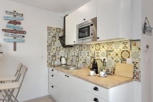a small kitchen with a sink and a microwave at La Playa by Lion Apartments in Sopot