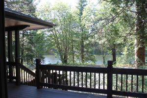 a porch of a cabin with a view of a river at Mount Shasta Resort in Mount Shasta