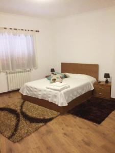 a bedroom with a bed and a dresser and a bed sidx sidx at Casa d'Avó Faia in Morais