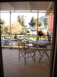 a table and chairs on a patio with a view at Prokimea Seaview Apartments in Lefkada