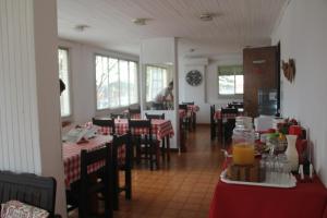 a restaurant with tables and chairs and a person in the background at Hotel Vuelta del Ombu in Gobernador Ingeniero Valentín Virasoro