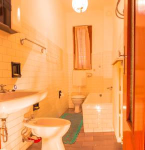 a bathroom with a sink and a toilet and a tub at Balcon des Alpes in Teglio