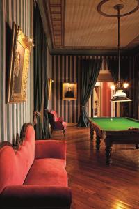 a living room with a pool table in it at Hotel Casa Real - Viña Santa Rita in Santiago