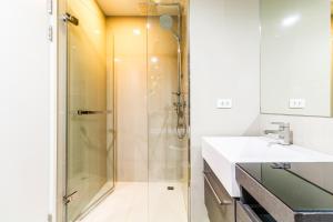 a bathroom with a shower and a sink at The Deck Condominium by Lofty in Patong Beach