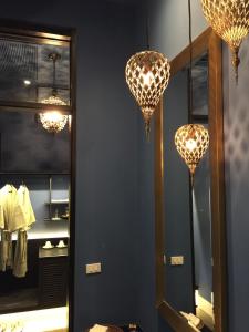 a bathroom with two chandeliers and a mirror at iuDia Hotel in Phra Nakhon Si Ayutthaya