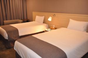 Postel nebo postele na pokoji v ubytování Hotel Shalom Jeju