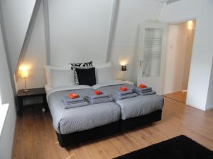 a bedroom with a large bed with oranges on it at Frankendael Apartments in Amsterdam