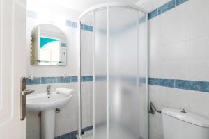a bathroom with a shower and a sink and a toilet at Panorama Apartments updated with infinity pool in Agios Nikolaos