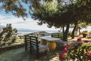 a table and chairs with a view of the ocean at Panorama Apartments updated with infinity pool in Agios Nikolaos