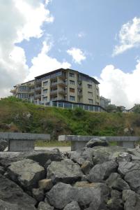 a building on top of a hill with rocks at La Casa Primorsko in Primorsko