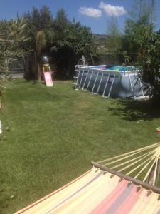 a backyard with a pool and a trampoline at Casa Vacanze Borgo Borghese in SantʼAlessio Siculo