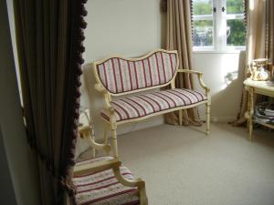a room with a rocking chair and a window at Country Lane Homestay B&b in Palmerston North