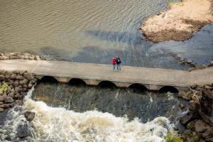 a person standing on a ledge near a body of water at Discovery Parks - Hadspen in Hadspen