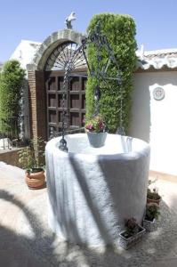 a bath tub sitting in front of a fence at Casa Grande de El Burgo in El Burgo