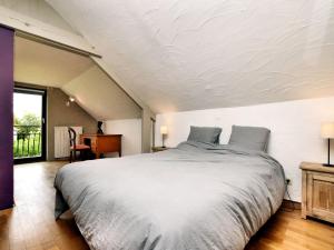 a bedroom with a large bed and a desk at Holiday Home in Virton with swimming pool in Virton