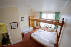 a bedroom with a bunk bed in a room at Queensbridge Hotel in Aberystwyth