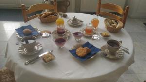 a white table with breakfast foods and drinks on it at Chambres d'hotes Saint Malo La Barbinais Bed&Breaksfast in Saint Malo