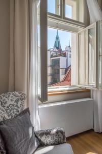 a living room with a window overlooking a city at Mordecai 12 Apartments by Prague Residences in Prague