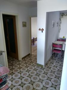 a hallway with a room with a table and a door at Suran Apartments in Pula