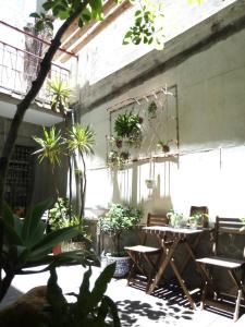 a patio with tables and chairs and potted plants at 想起天井老宅民宿Thinking Homestay in Tainan
