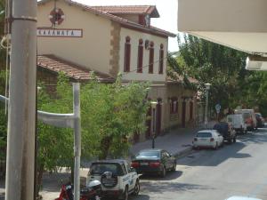 a street with cars parked on the side of a building at Hotel George in Kalamata