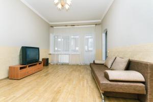 a living room with a couch and a tv at Apartment on Khreshchatyk in Kyiv