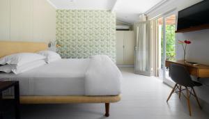ケープタウンにあるCape Standard Guest Houseのベッド、机、テレビのある寝室