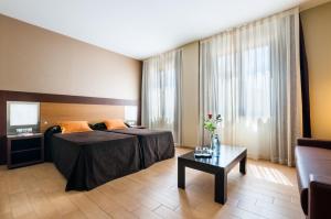 Postel nebo postele na pokoji v ubytování Hotel Ciudad de Alcañiz