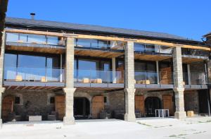 an external view of a building with large windows at Mas Ravetllat in Isóbol