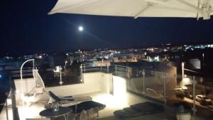 a balcony with a view of a city at night at Le Terrazze in Otranto